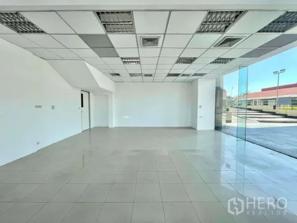 Retail Space for rent in Yan Nawa, Bangkok - Open-plan retail floor with suspended ceiling, AC vents and floor-to-ceiling corner glazing.