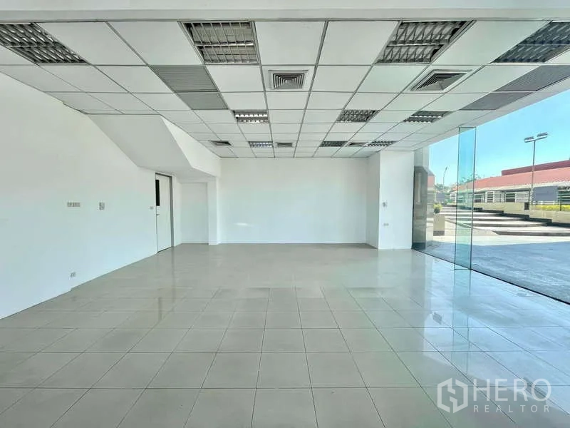 Retail Space for rent in Yan Nawa, Bangkok - Open-plan retail floor with suspended ceiling, AC vents and floor-to-ceiling corner glazing.
