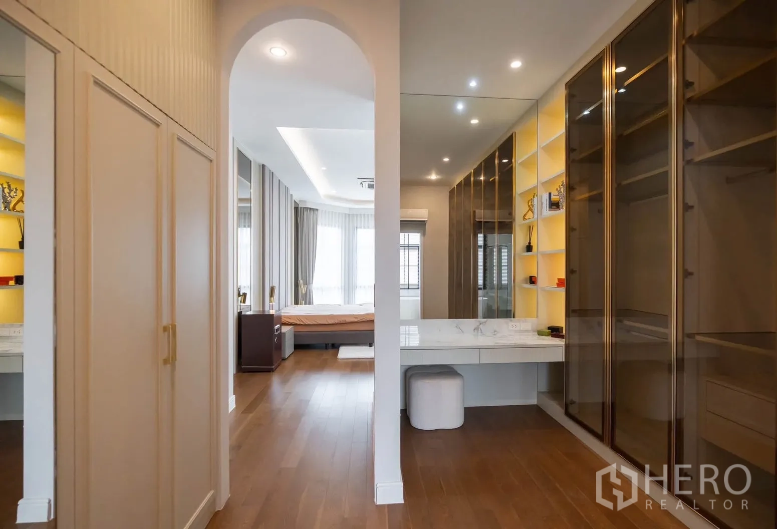 Detached House for rent or sale in Bang Kapi, Bangkok - Walk-in closet with built-in wardrobes, lighted shelves, and a dressing table.