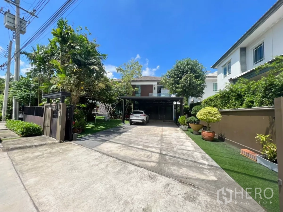 Detached House for rent or sale in Bang Kapi, Bangkok - Gated detached house with long driveway, carport for multiple cars and lush garden in the Krungthep Kreetha area.