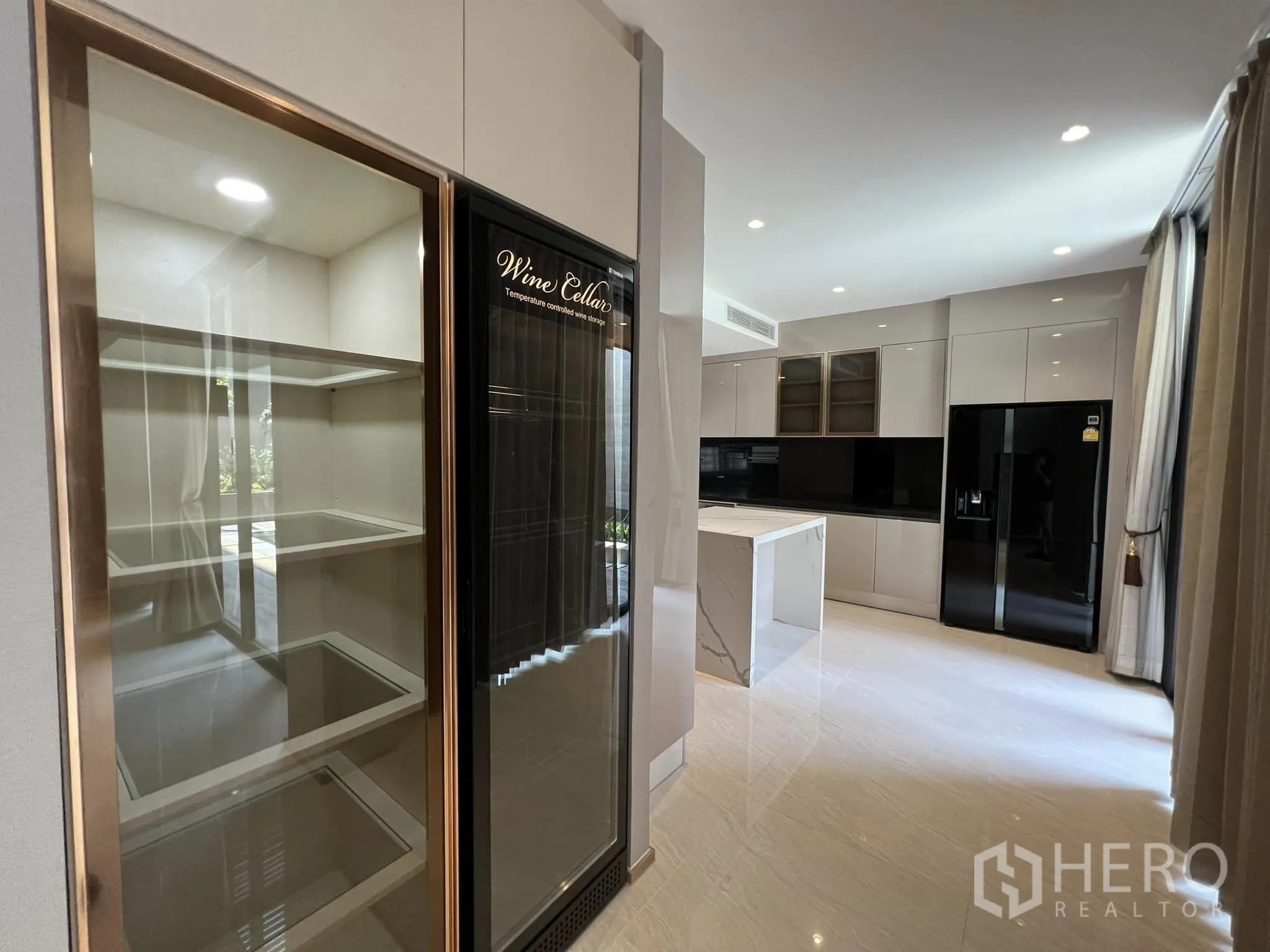 Detached House for rent or sale in Yan Nawa, Bangkok - Gourmet kitchen with glass wine cellar cabinets and central island.