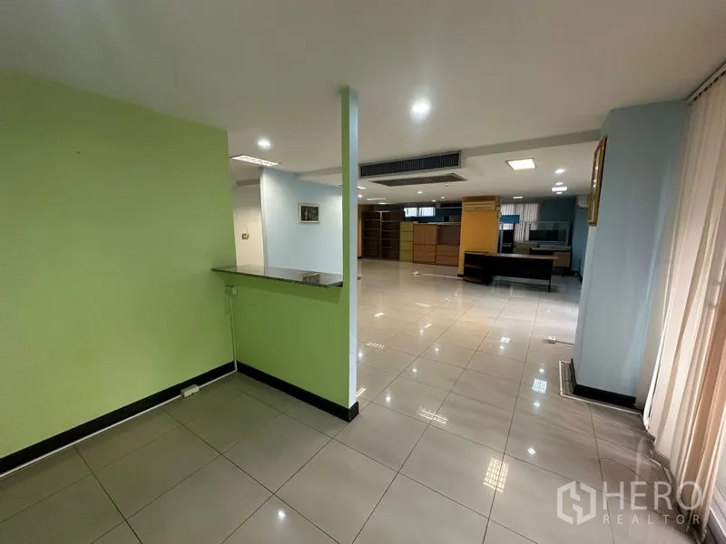Office Space for sale - Reception nook with counter overlooking a spacious open office area.