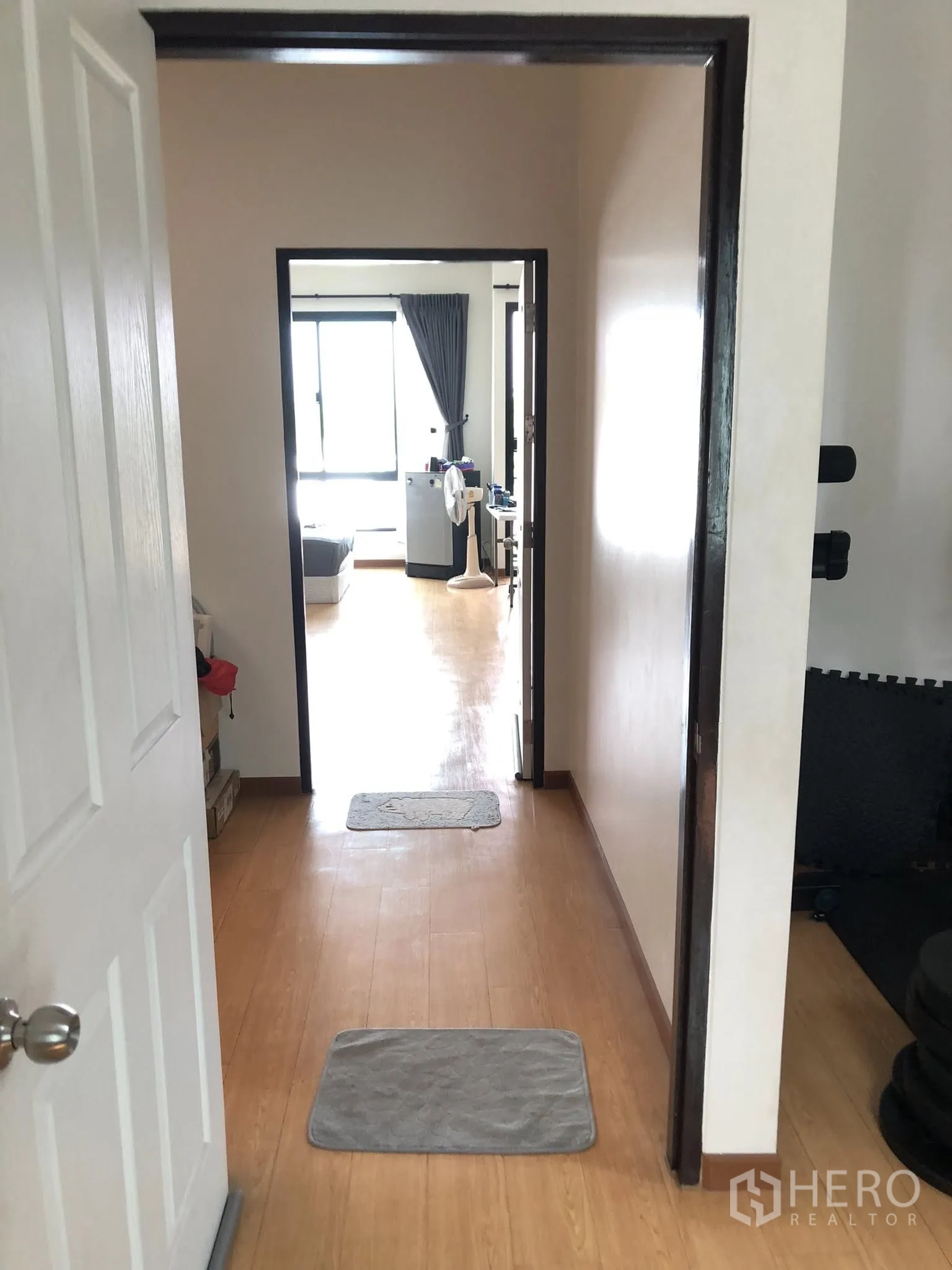 Townhouse for sale in Phra Khanong, Bangkok - Upper-floor hallway with wood flooring leading between bedrooms.