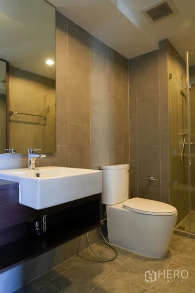 คอนโด ขายในWatthana, Bangkok - ห้องน้ำสมัยใหม่พร้อมตู้ Shower กระจก อ่างล้างหน้าเหลี่ยม และกระเบื้องโทนอบอุ่น