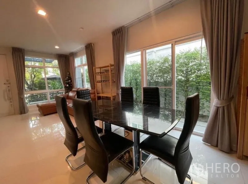 Detached House for rent in Lat Krabang, Bangkok - Open-plan dining and living space with garden-view sliding doors and tiled floors