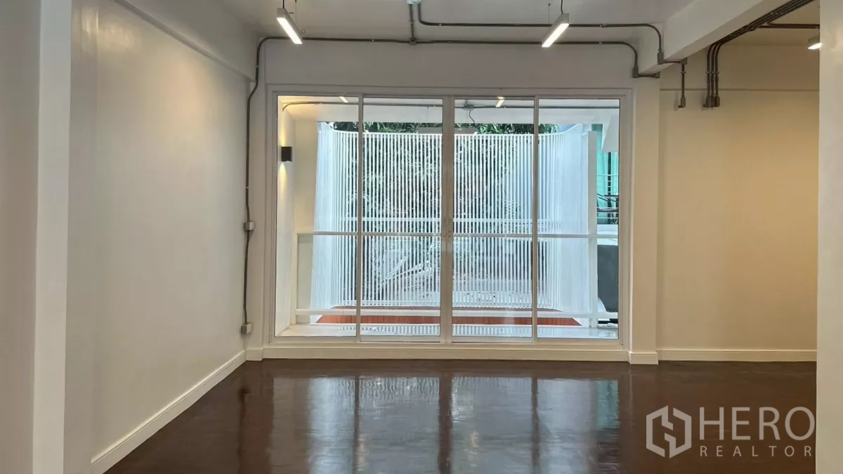 Home Office for rent in Watthana, Bangkok - Room with large window looking toward vertical white privacy louvers.