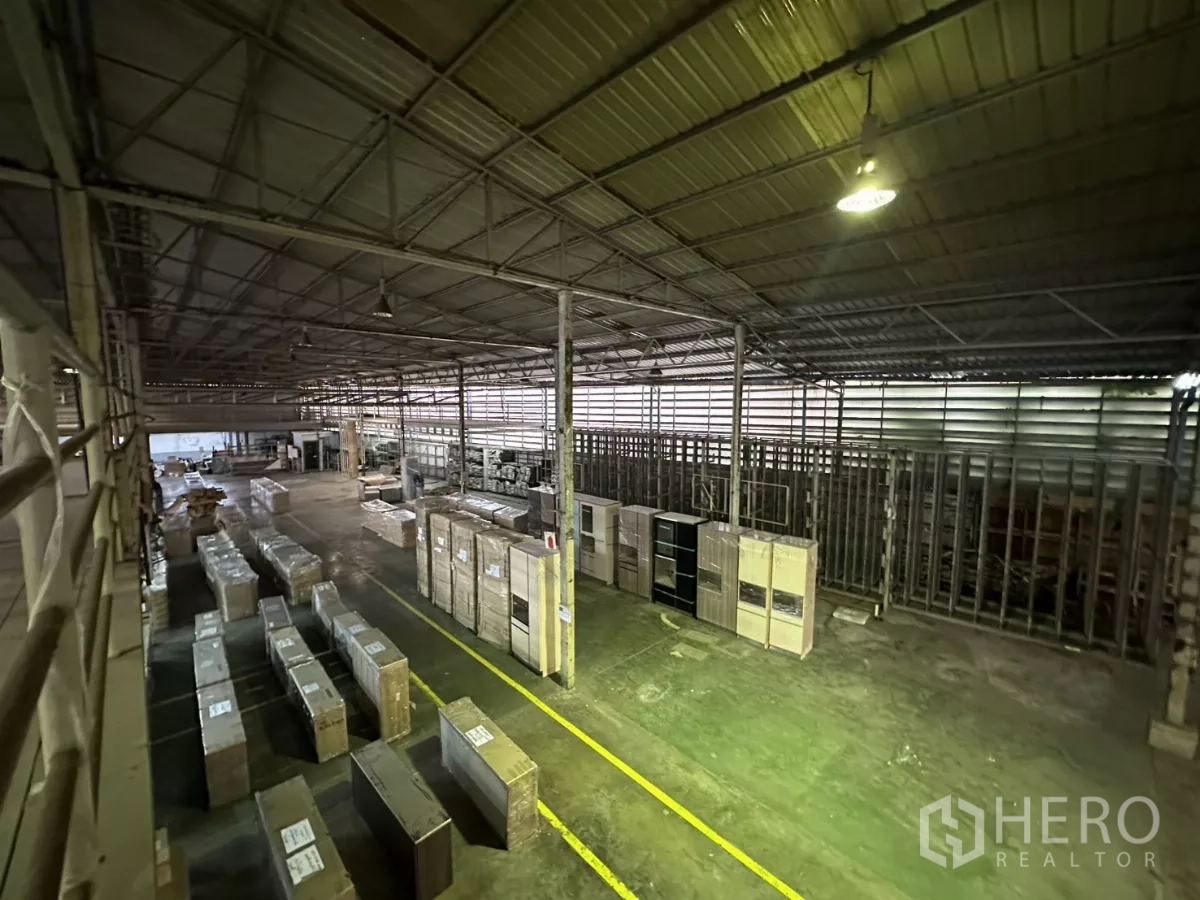 Warehouse for rent in Yan Nawa, Bangkok - View from mezzanine over inventory rows and steel rack systems.
