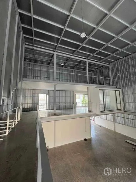 Home Office for rent or sale - Double-height industrial studio with metal walls and suspended rooms.