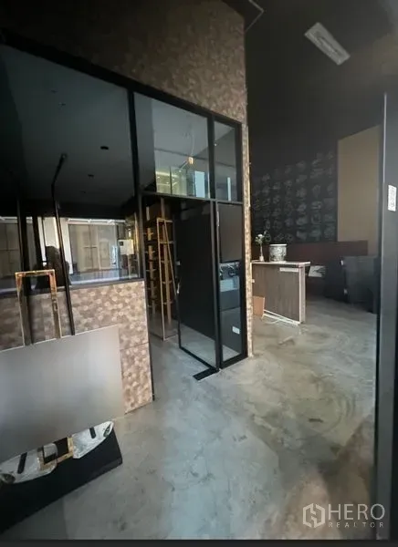 Retail Space for rent in Watthana, Bangkok - Retail interior with glass partition walls, concrete floor and a counter area.