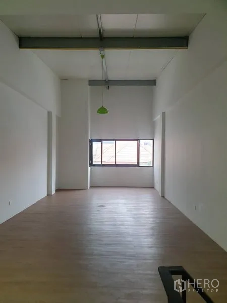 Home Office for rent in Bang Rak, Bangkok - Top-floor workspace with high ceiling, exposed beam, and wood-style flooring.