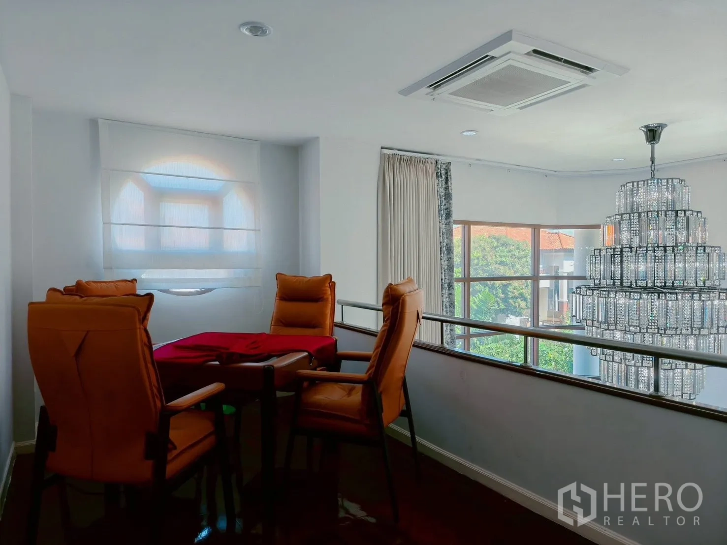 Detached House for rent in Lat Krabang, Bangkok - Mezzanine lounge with four orange chairs beside double‑height window and chandelier.