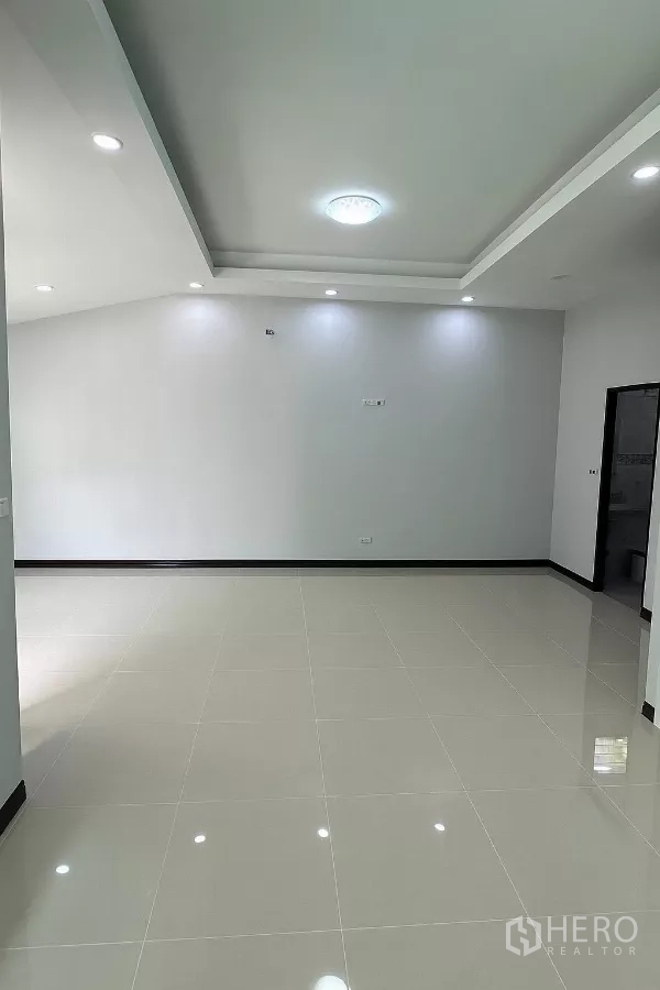 Home Office for rent in Bang Phli, Samut Prakan - Open-plan workspace with polished floor tiles and modern tray ceiling lighting.