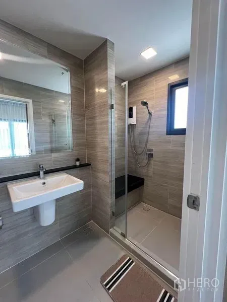 Detached House for rent or sale - Contemporary bathroom with glass shower enclosure and wall mirror.