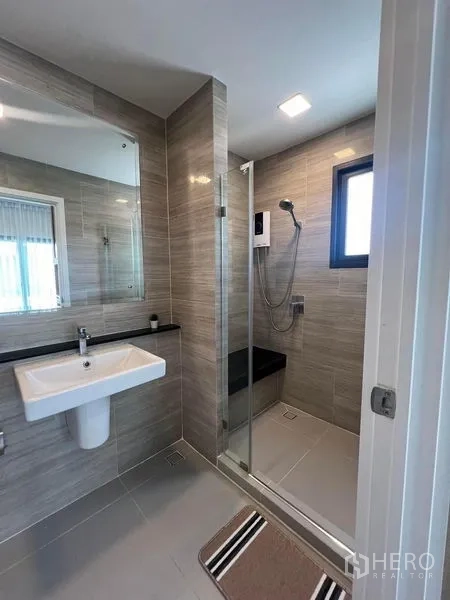 Detached House for rent or sale - Contemporary bathroom with glass shower enclosure and wall mirror.