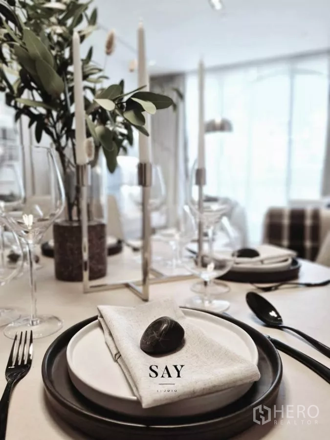 Condominium for rent or sale in Khlong Toei, Bangkok - Elegant dining table setting with candles, glassware and linen napkins.