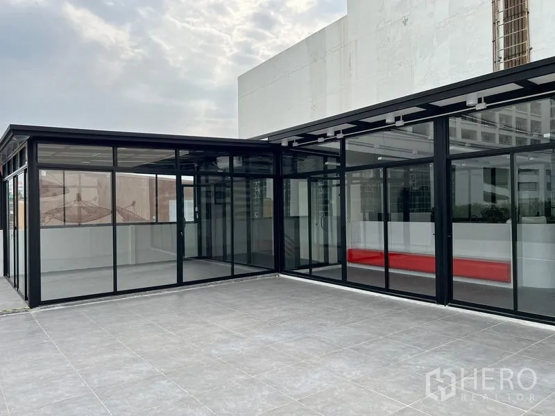 Retail Space for rent in Watthana, Bangkok - Modern glass pavilion storefront opening to a spacious tiled terrace.