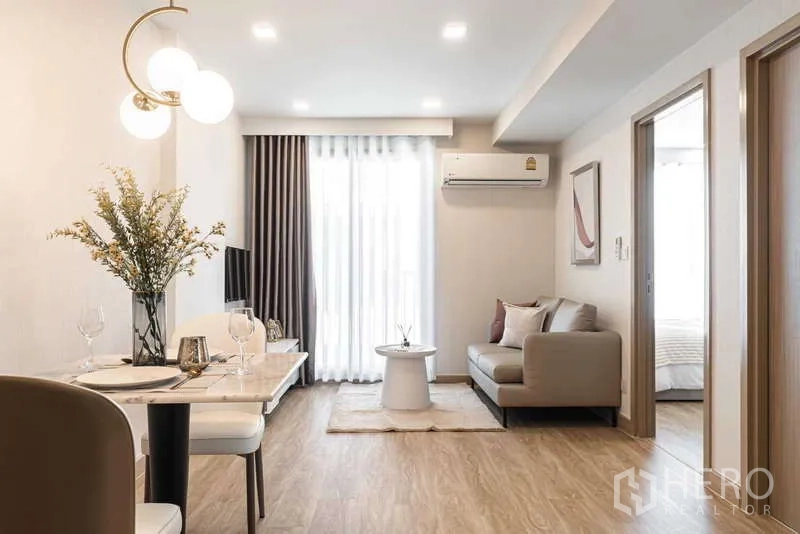 Condominium for rent - Bright open-plan living and dining area with marble table, sofa, and balcony light at Maestro 07 condo.