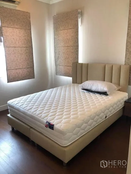 Detached House for rent or sale - Bright guest bedroom with beige upholstered bed and Roman blinds.