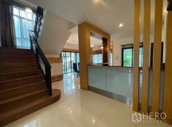 Detached House for rent in Chatuchak, Bangkok - Wood staircase beside a pantry and counter area with garden outlook.