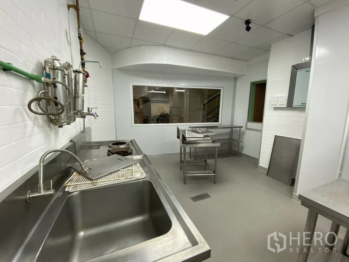 Retail Space for rent - Wash area with deep sinks, plumbing fixtures and window to the dining space.