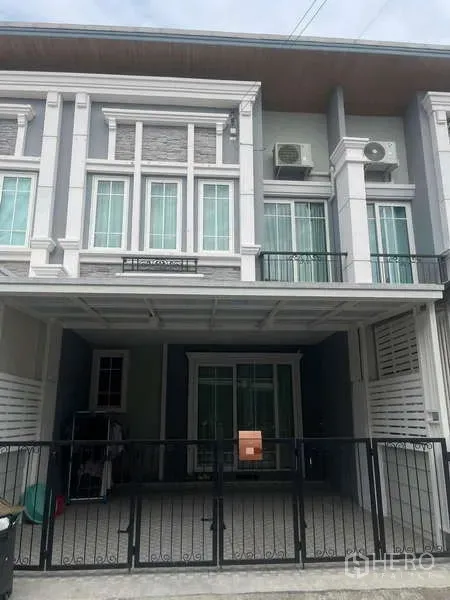 Townhouse for rent or sale - Modern two-storey townhouse facade with gated covered carport.