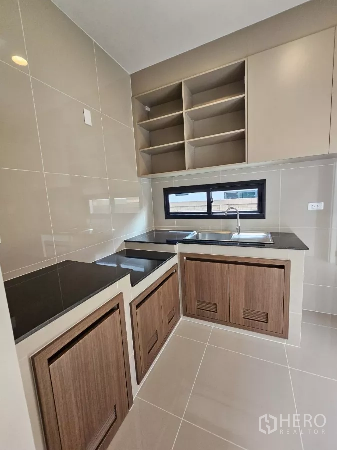 Detached House for sale in Lam Luk Ka, Pathum Thani - Separate Thai kitchen with sink, shelving and tiled walls.