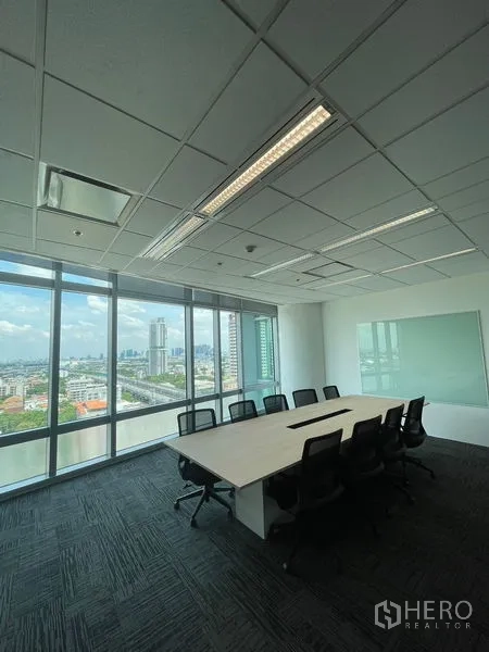 Office Space for rent in Dusit, Bangkok - Boardroom with long conference table, whiteboard, and skyline backdrop.