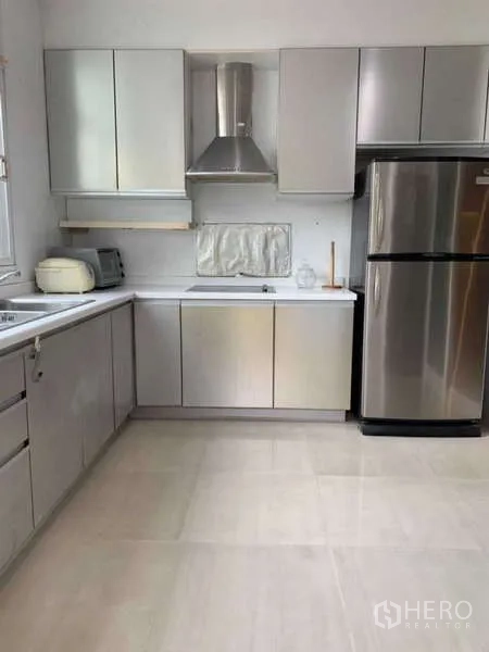 Detached House for rent in Lat Krabang, Bangkok - Modern kitchen with stainless cabinets, cooker hood and large refrigerator.