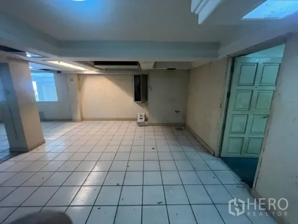 Retail Space for rent in Watthana, Bangkok - Tiled retail room with recessed lighting and a doorway leading to additional space.