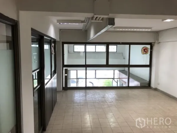 Office Space for rent in Huai Khwang, Bangkok - Bright office room with large windows and glass partitions.
