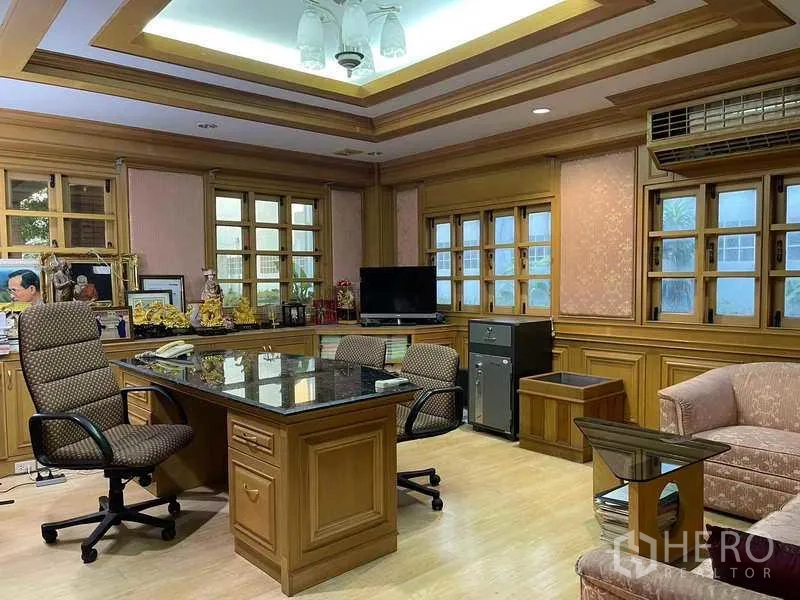 Factory for rent in Phra Samut Chedi, Samut Prakan - Wood‑paneled executive office with desk, seating and multiple windows.
