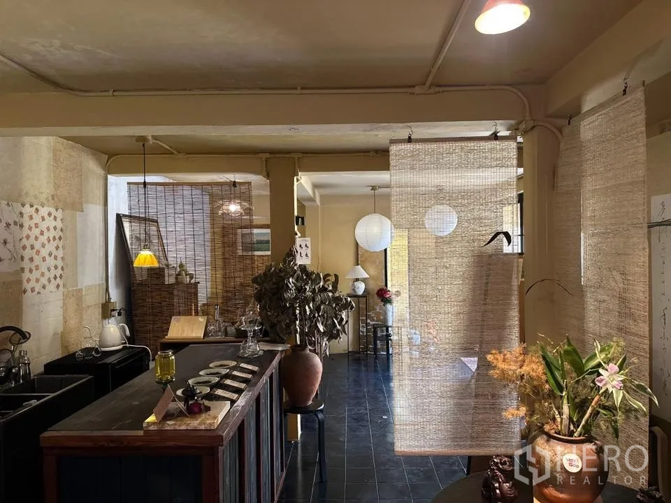 Retail Space for rent in Khlong Toei, Bangkok - Retail area with a bar-style counter, hanging woven screens, and decorative plants.