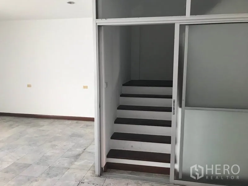 Office Space for rent in Khlong Toei, Bangkok - Internal staircase behind a glass sliding partition inside the office.