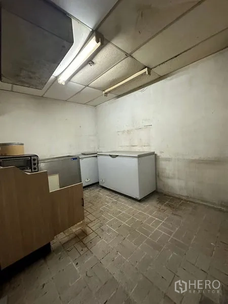 Retail Space for rent in Yan Nawa, Bangkok - Storage room containing chest freezers under fluorescent lighting.