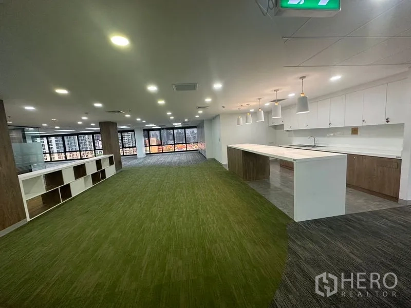Office Space for rent in Khlong Toei, Bangkok - Breakout area with a long island pantry, pendant lights and large windows.