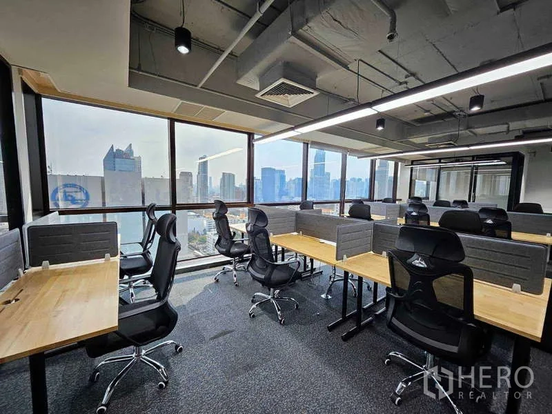 Office Space for rent in Ratchathewi, Bangkok - Open-plan workspace with cubicles, mesh chairs, linear LED lighting and skyline backdrop.