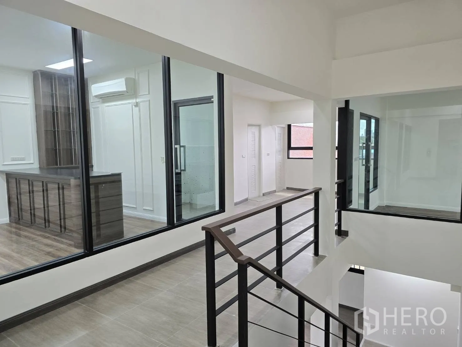 Home Office for rent in Chatuchak, Bangkok - Upper-floor landing with glass partitions overlooking offices and corridors.