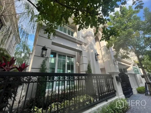 独立式住宅 出售在Yan Nawa, Bangkok - 独栋别墅外立面，米色墙面、黑色锻铁围栏与绿化景观，位于Chong Nonsi。
