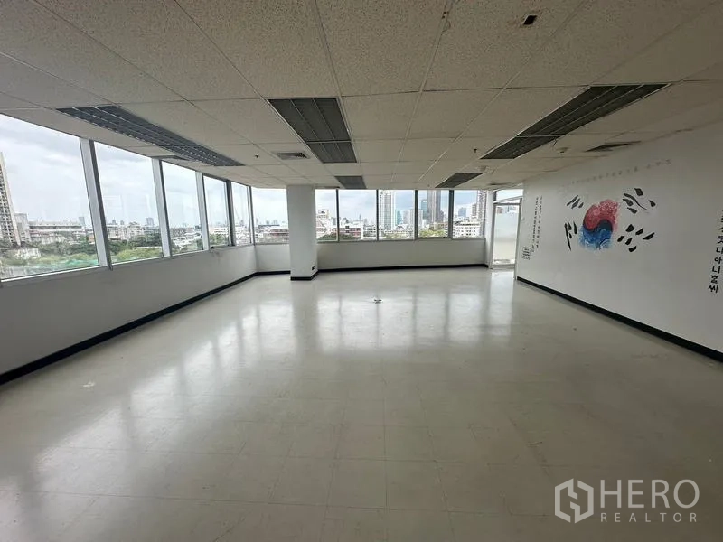 Office Space for rent - Large open-plan office with wraparound windows and city views bringing abundant natural light.