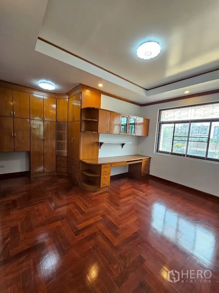 带办公室的家 for rent in Wang Thonglang, Bangkok - 卧室或办公室，整墙木质柜体与书桌，木地板。