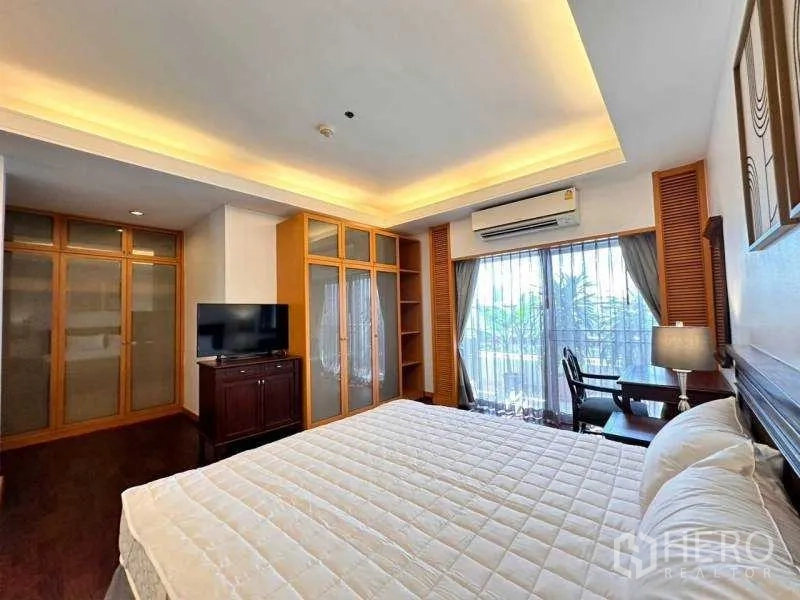 Apartment for rent - Master bedroom with large wardrobes, TV cabinet and study desk by the window.