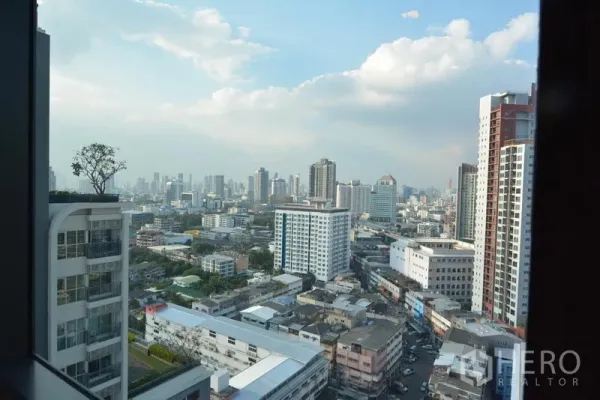 Condominium for sale in Khlong Toei, Bangkok - High-floor view across Khlong Toei with Bangkok skyline and mid-rise buildings.