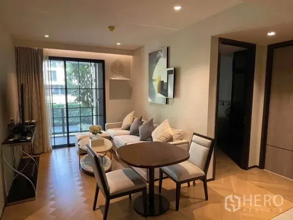 Condominium for rent - Cozy living area with TV console, sectional sofa and sliding doors opening to the balcony.