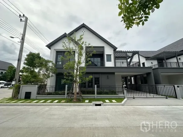 Detached House for rent or sale in Bang Phli, Samut Prakan - Front façade showing driveway, covered parking and landscaped garden