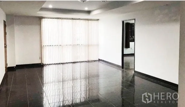 Office Space for rent or sale in Don Mueang, Bangkok - Room with glossy dark tiles, recessed ceiling, large window with vertical blinds and doorway to side room.