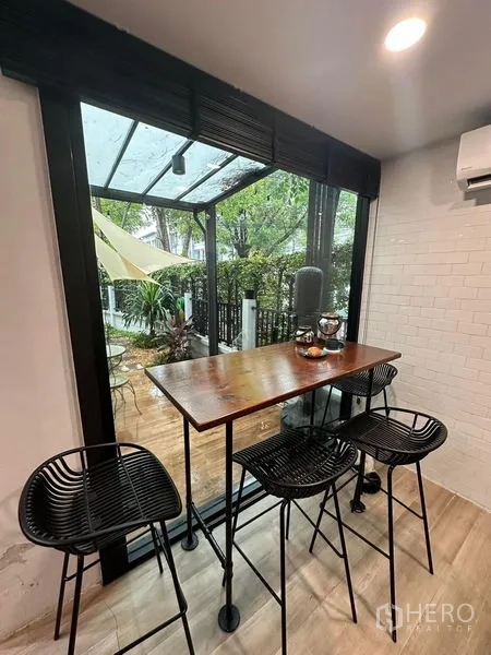 联排别墅 出售在Wang Thonglang, Bangkok - 落地窗旁早餐吧台，眺望花园露台。