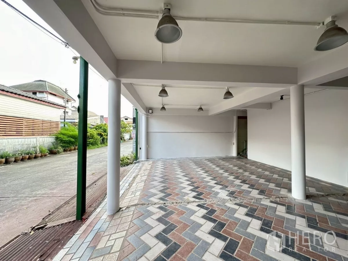 Home Office for rent in Lat Phrao, Bangkok - Covered multi-car parking area with chevron paver floor and ceiling lights