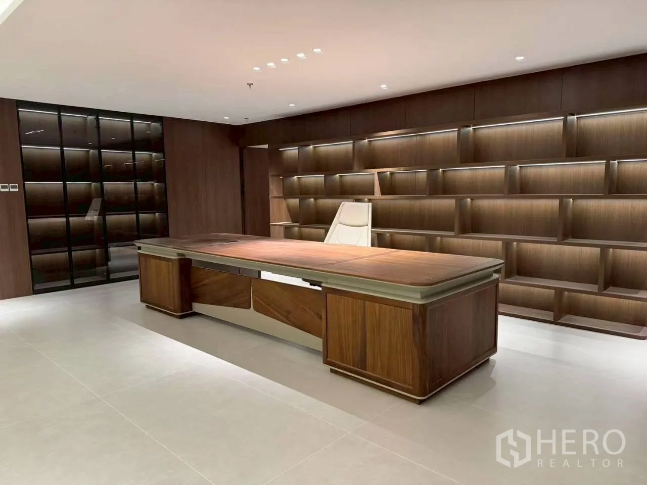 Office Space for rent in Din Daeng, Bangkok - Executive suite with a grand wooden desk and illuminated wall shelving.