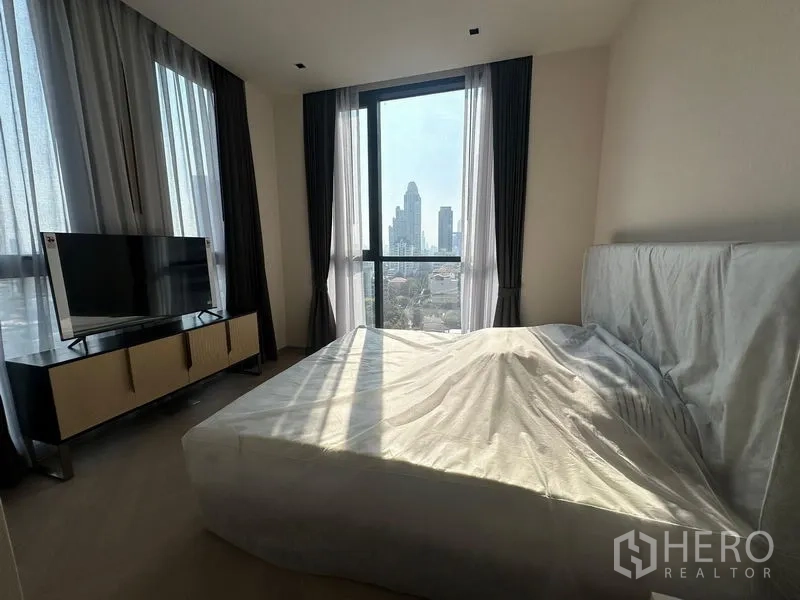 Condominium for rent - Bedroom window framing a Bangkok city skyline view.