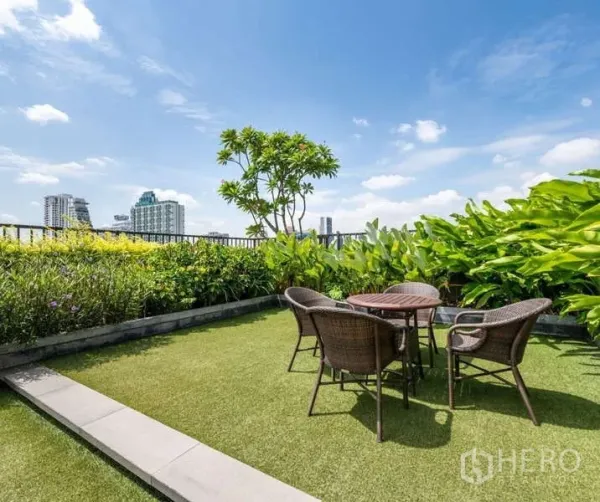 Condominium for rent - Sky garden terrace with outdoor table and chairs amid lush plants and city views.